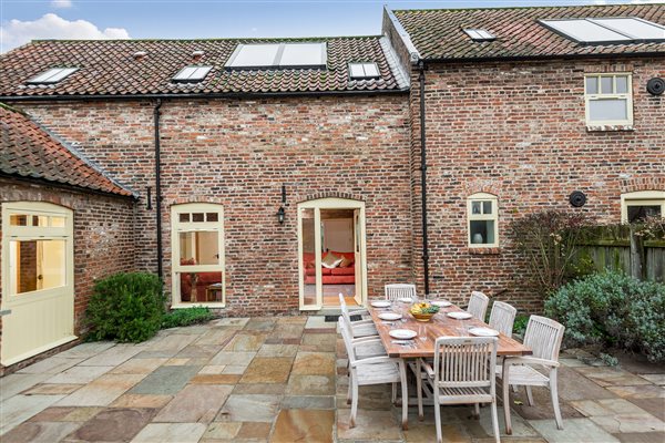 Courtyard with large dining table and chairs